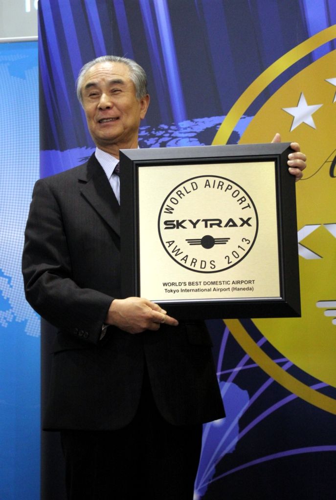 Japan Airport Terminal's President, Isao Takashiro holds the Skytrax award for world's best domestic airport in 2013.